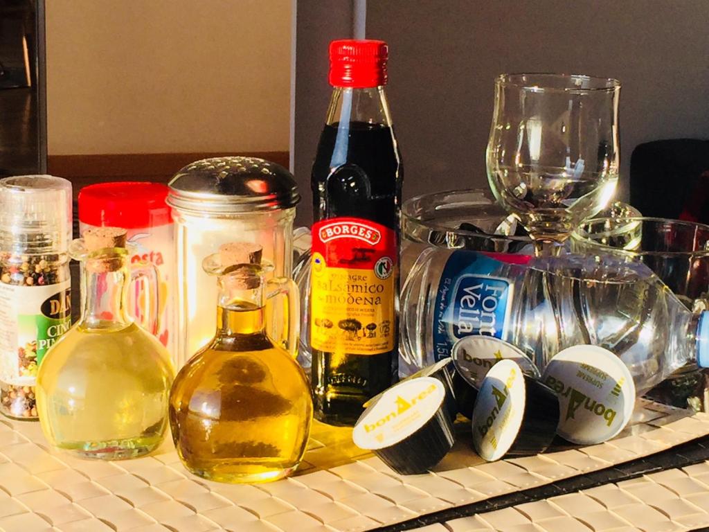 a counter with bottles of wine and glasses on it at Barceloneta Ramblas Apartments in Barcelona