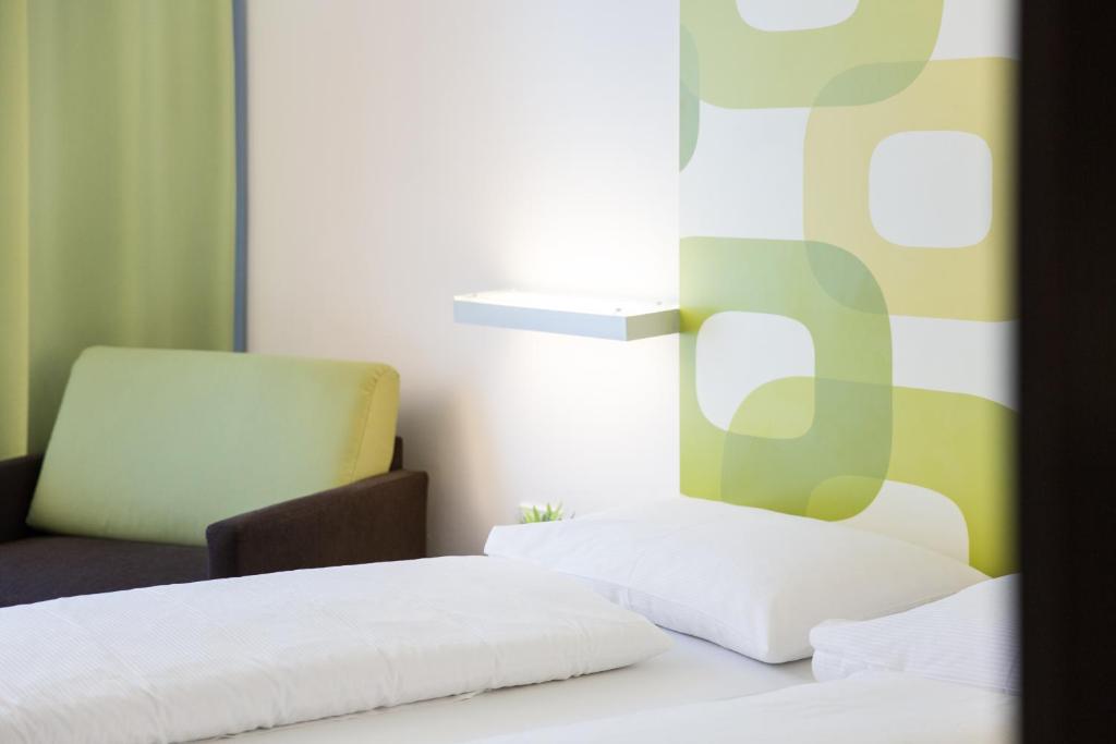 Posteľ alebo postele v izbe v ubytovaní arte Hotel Krems