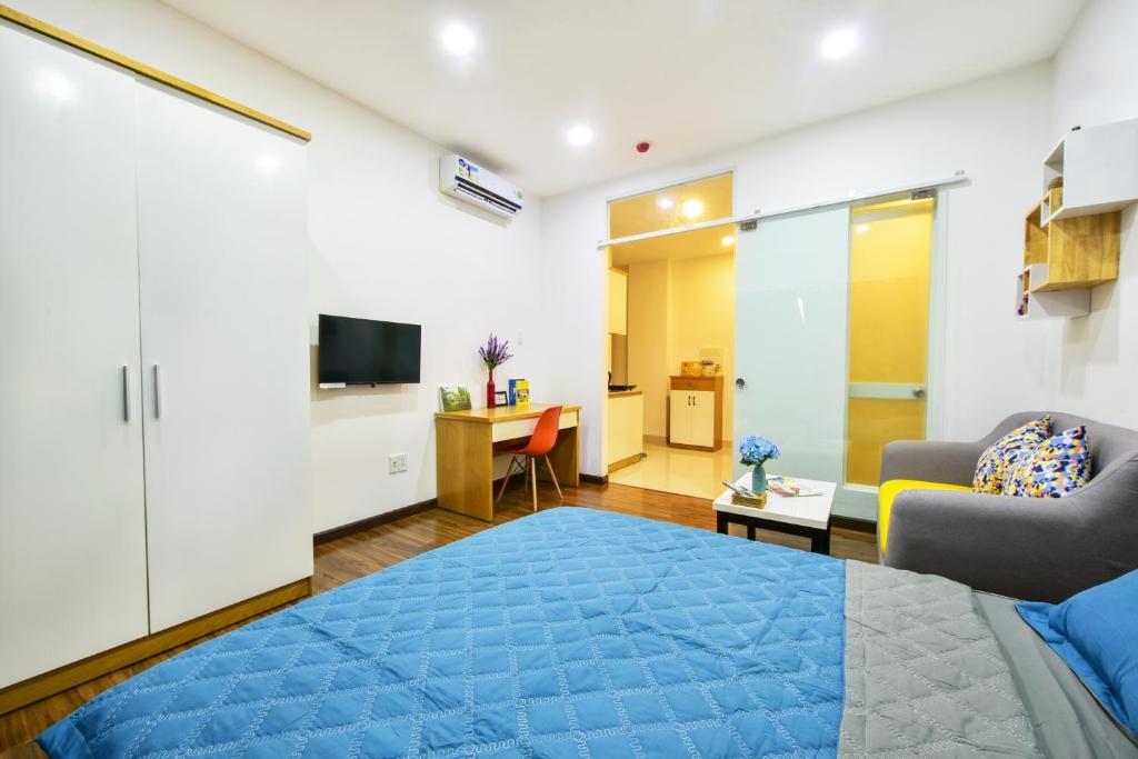 a bedroom with a bed and a living room at Sunrisehome in Ho Chi Minh City