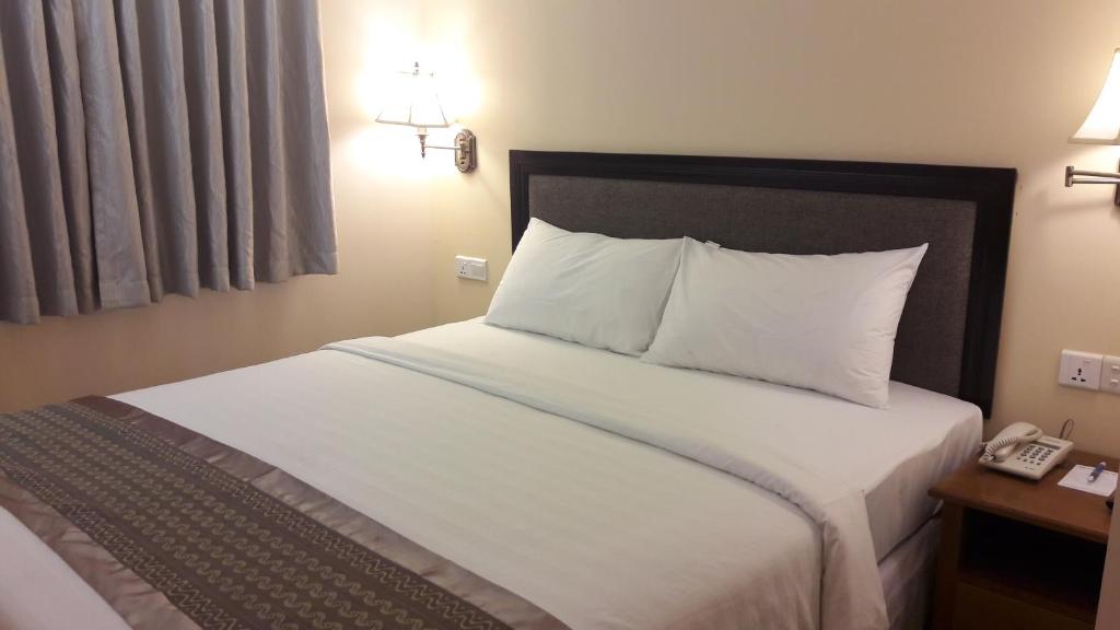 Postel nebo postele na pokoji v ubytování Grand Laurel Hotel