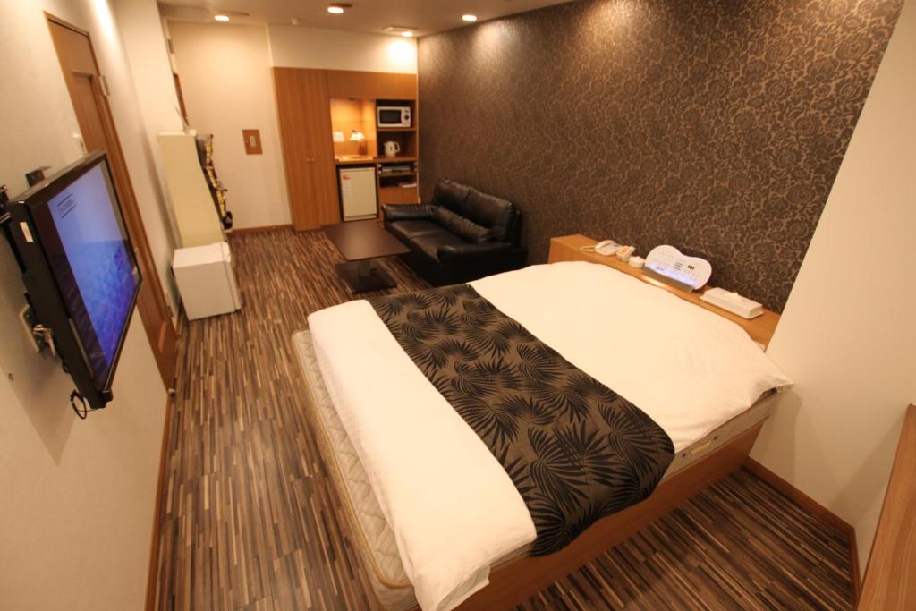 a hotel room with a bed and a television at Hotel Shindbad Aomori -Love Hotel- in Aomori