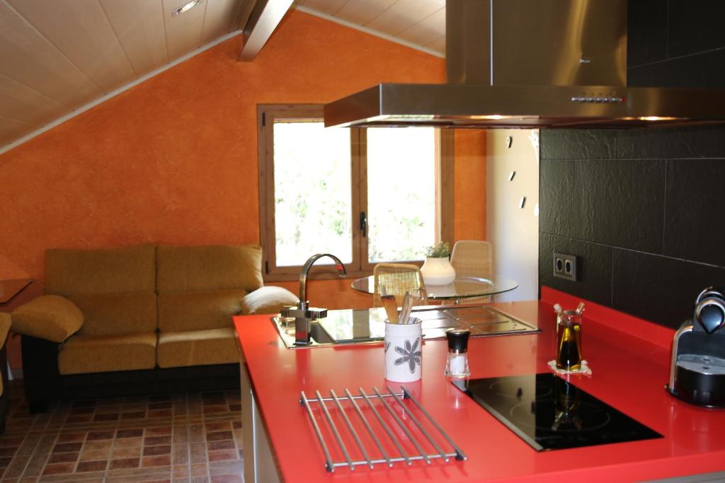 a kitchen with a red counter top and a couch at Casablanca in Badalona