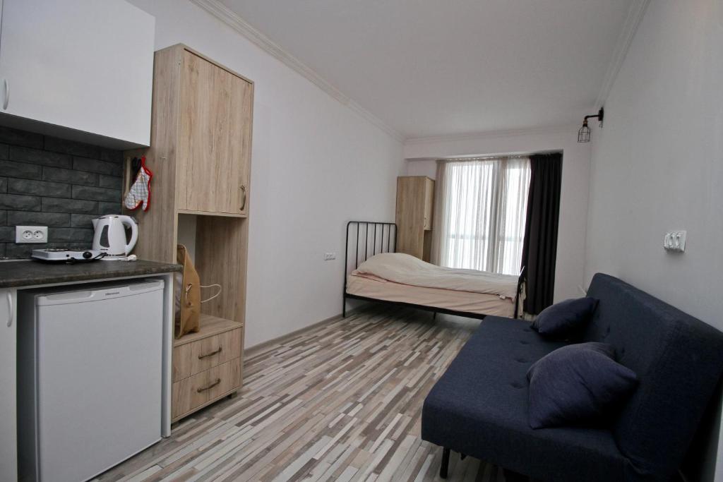 a living room with a couch and a bedroom at Apartment N318 Gudauri Loft in Gudauri