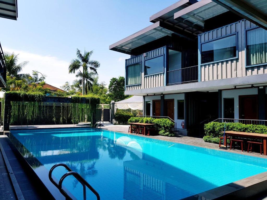 a swimming pool in front of a house at Kluang Container Swimming Pool Hotel in Kluang