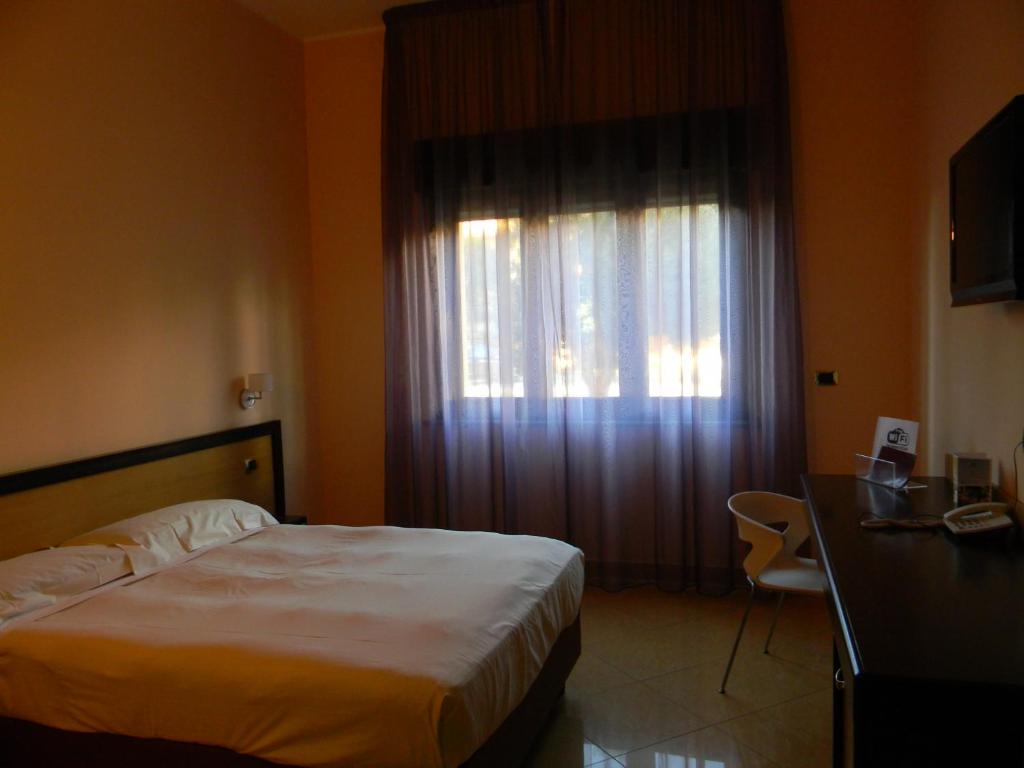 Postel nebo postele na pokoji v ubytování Grand Hotel Paradiso