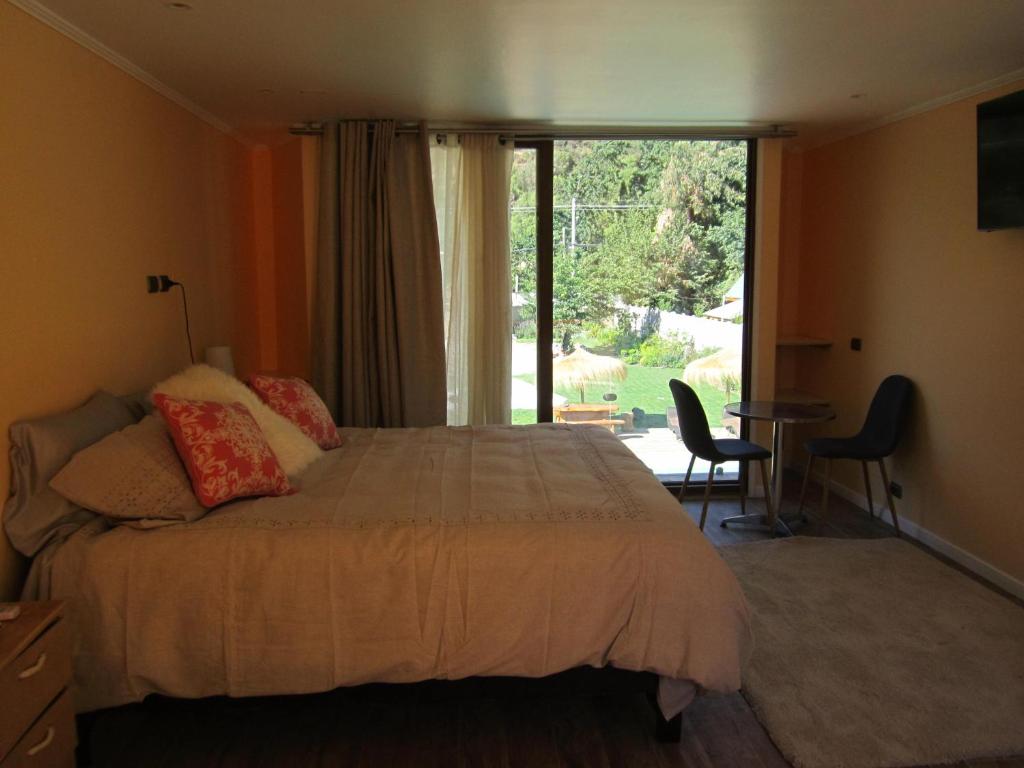 Postel nebo postele na pokoji v ubytování Cajón del Maipo Lodge