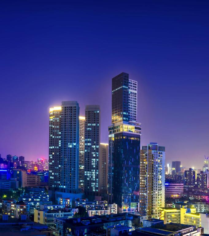 深圳深圳品上云端服务式公寓的一座城市在晚上点燃,有高楼