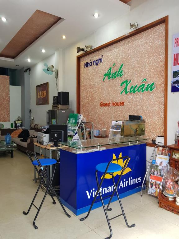 a store with a counter and chairs in a room at Anh Xuan Guest House in Hue