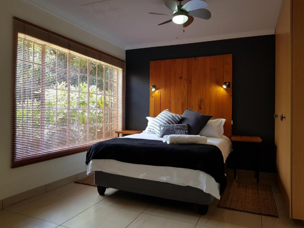 a bedroom with a large bed and a window at Kington Guest Suite in Pretoria