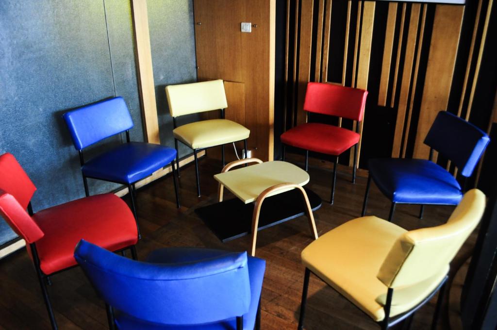 a row of colorful chairs in a room at Hotel le Corbusier in Marseille