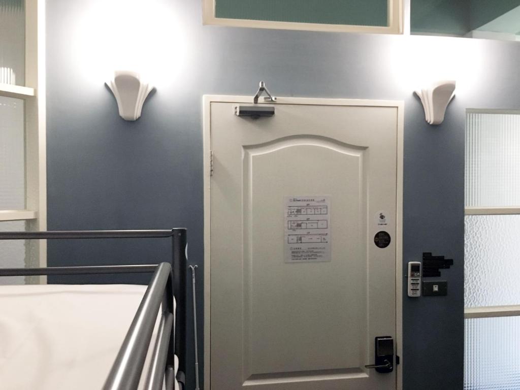 Postel nebo postele na pokoji v ubytování Tainan Gu Hostel