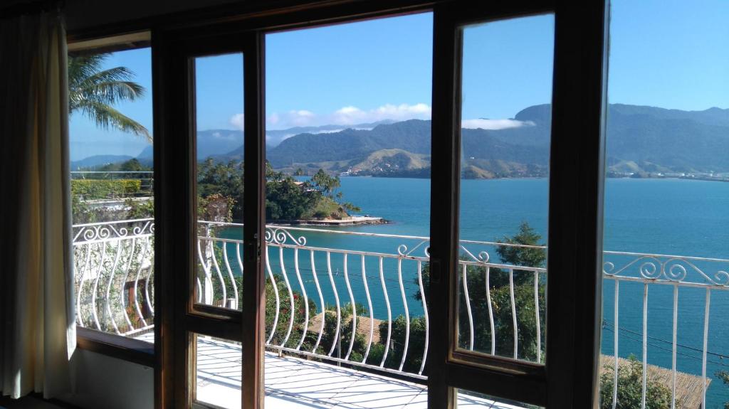 a view of the ocean from a hotel room window at Chalés Bocaina in Ilhabela