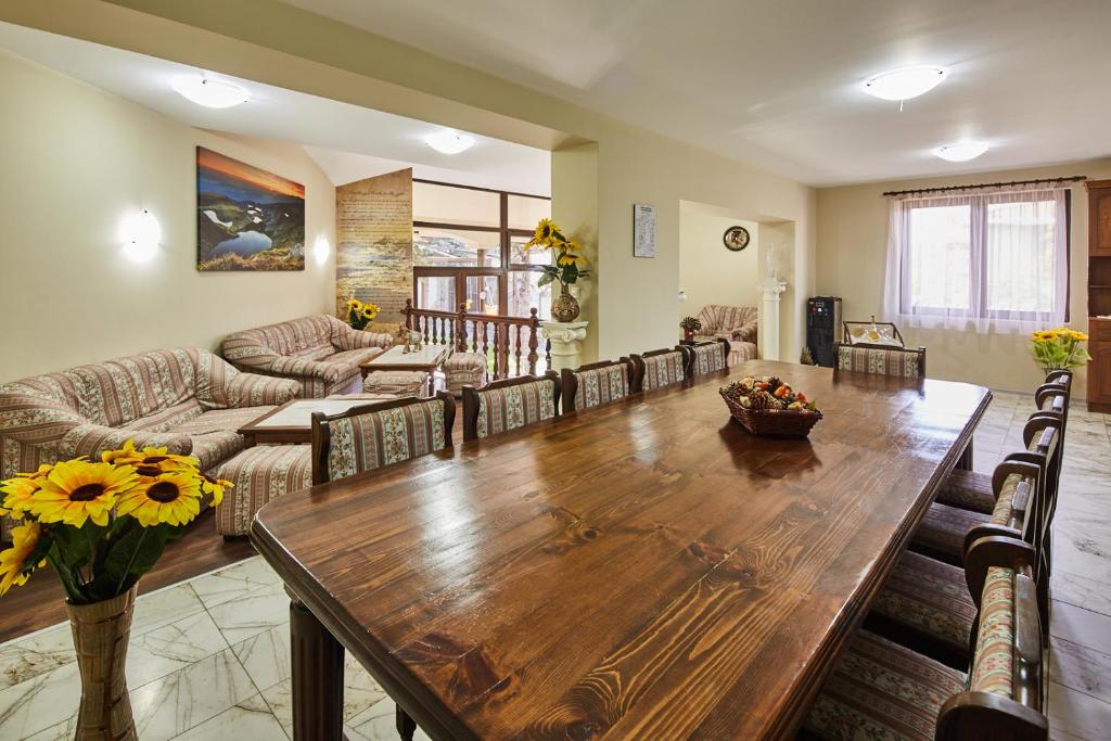 a living room with a wooden table and a couch at Guest House Mira in Sapareva Banya