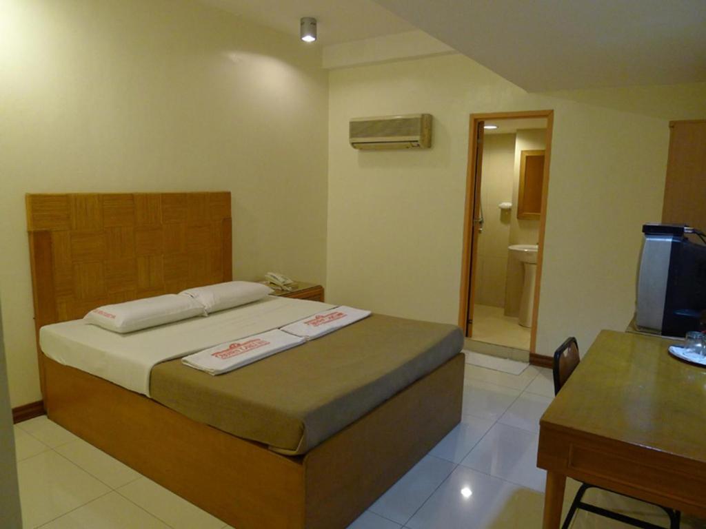 Postel nebo postele na pokoji v ubytování Cebuview Tourist Inn