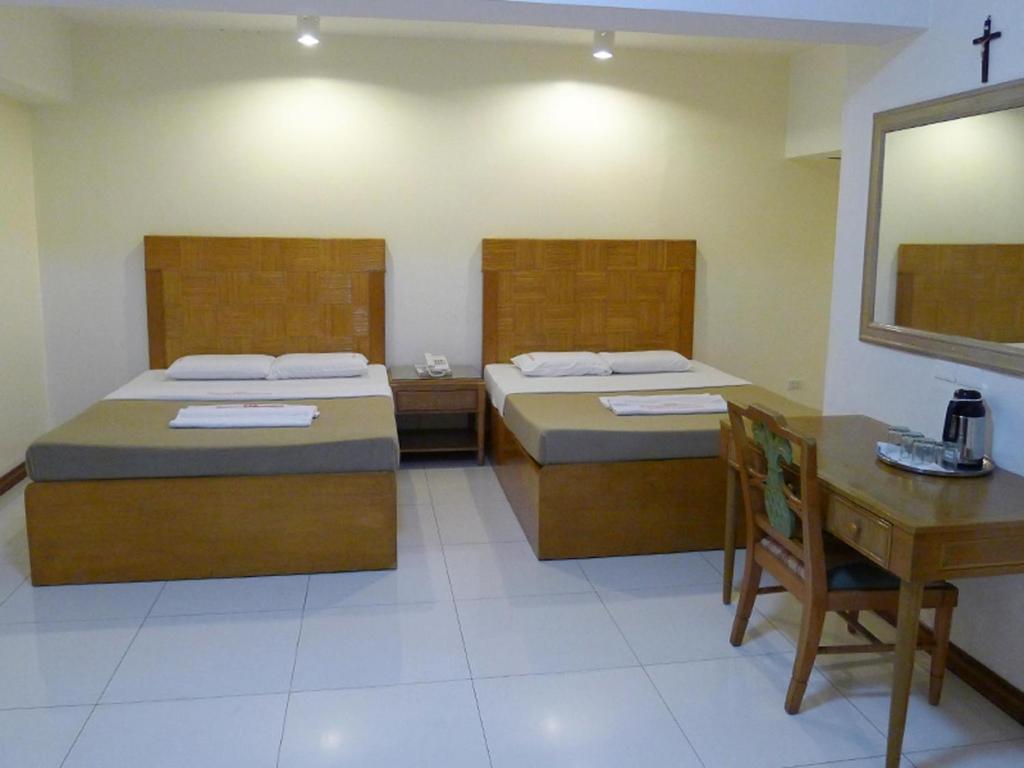 Postel nebo postele na pokoji v ubytování Cebuview Tourist Inn