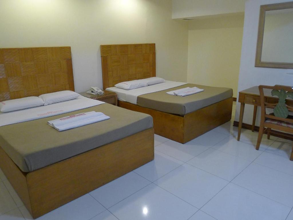 Postel nebo postele na pokoji v ubytování Cebuview Tourist Inn