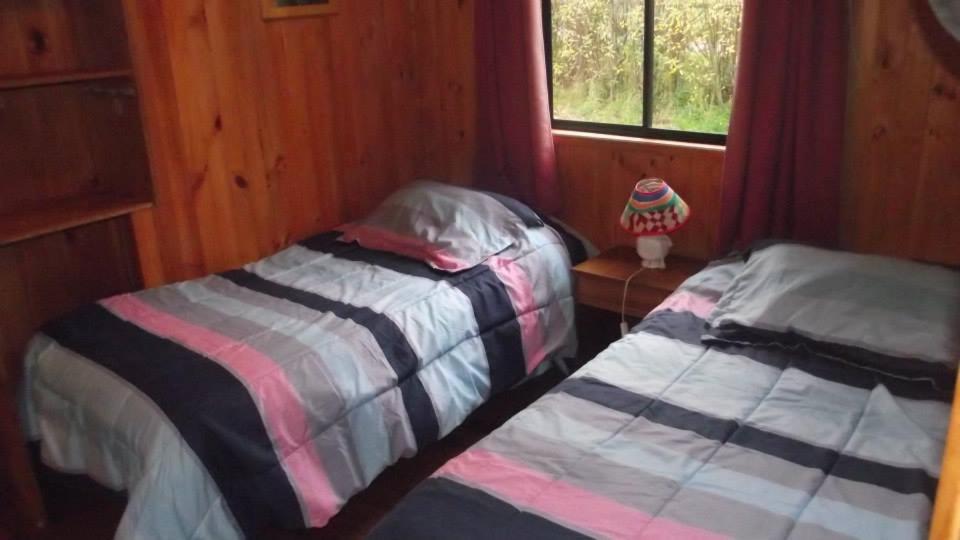 Postel nebo postele na pokoji v ubytování Hostal y Cabañas Mozart