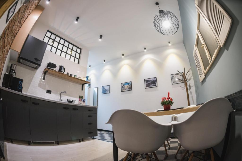 a kitchen with a dining table and two chairs at Zinne Apartments in Braşov