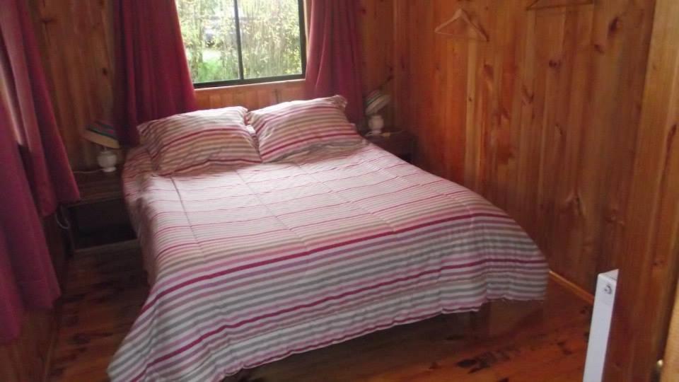 Postel nebo postele na pokoji v ubytování Hostal y Cabañas Mozart