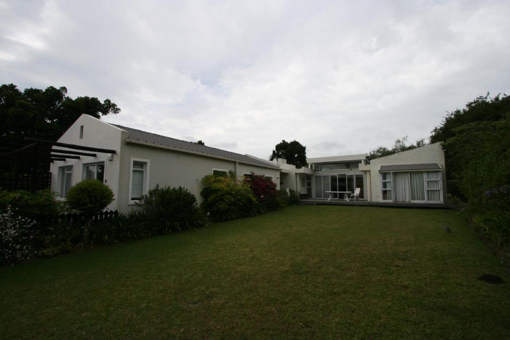 a house with a lawn in front of it at Home on Plato in Plettenberg Bay