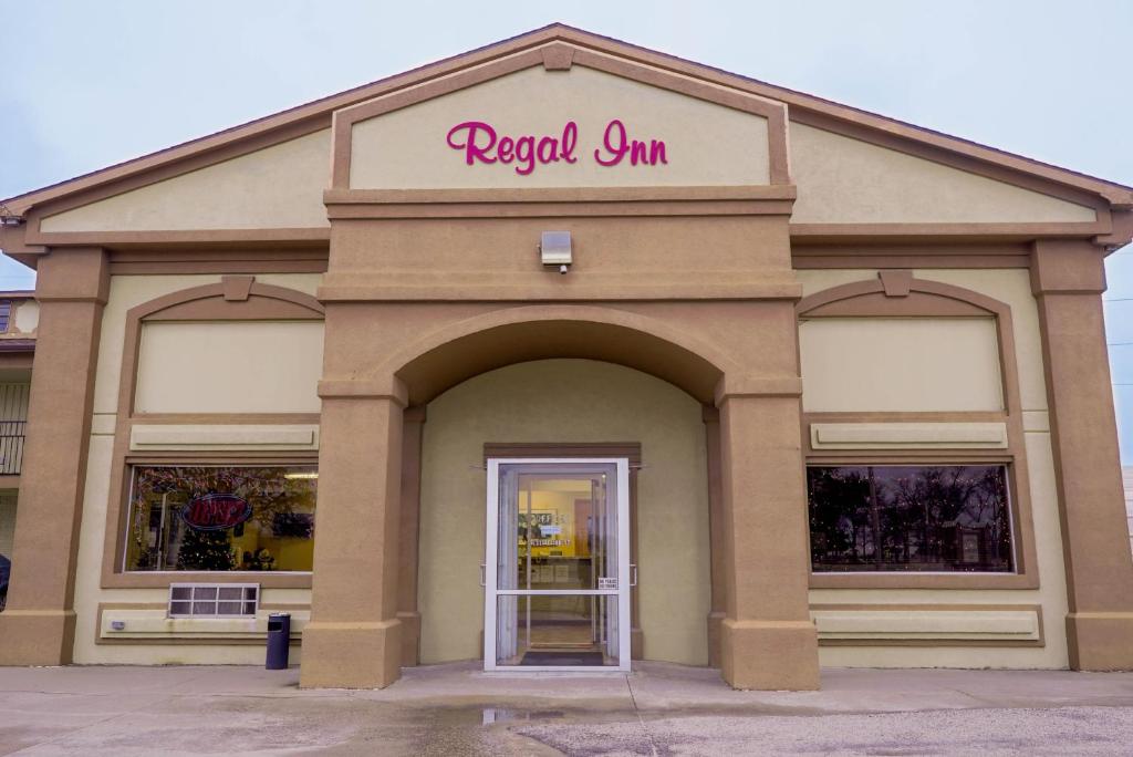 a store with a sign on the front of it at Regal Inn Coffeyville in Coffeyville