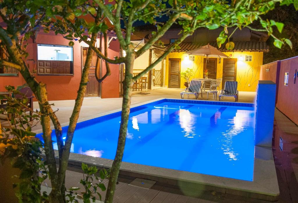 a swimming pool at night in a house at Pousada Manhã Dourada in Arraial d'Ajuda