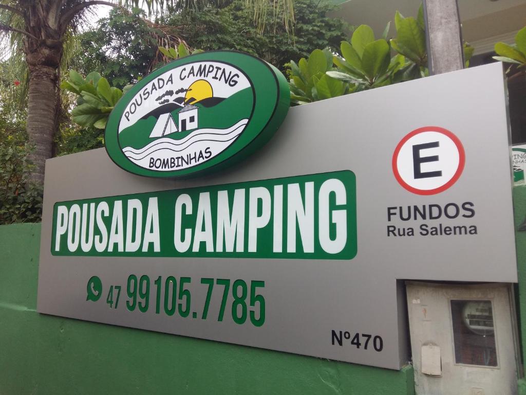 a sign for a pucadia camping sign at Pousada Camping Bombinhas in Bombinhas