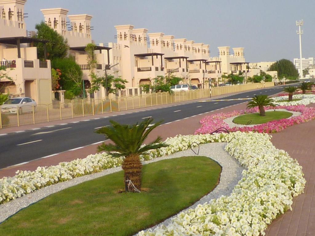 a street with flowers in the middle of a road at Townhouse Ras al Khaimah in Ras al Khaimah