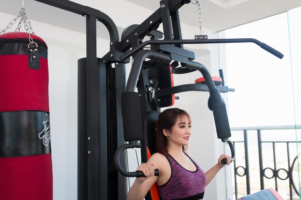 A compact fitness area with a multi-station weight machine and hanging punching bag.