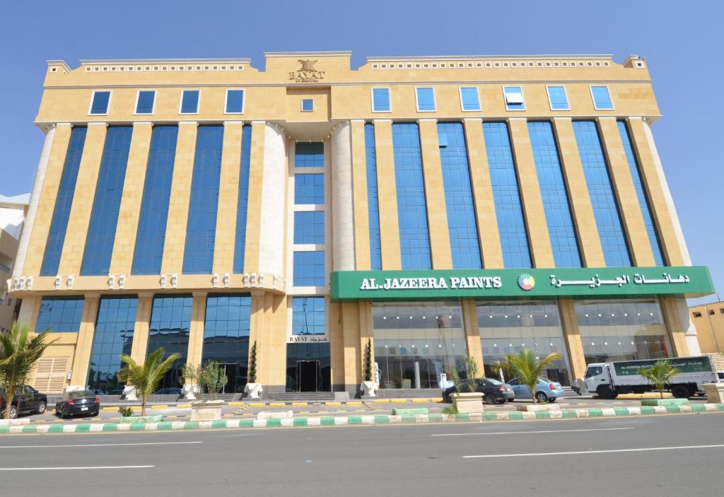 a building in the middle of a street at Bayat Suites in Muhayil