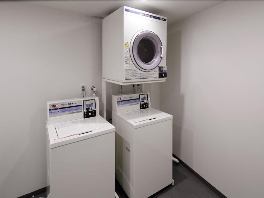 a laundry room with two washes and a washing machine at Shinjuku Granbell Hotel in Tokyo