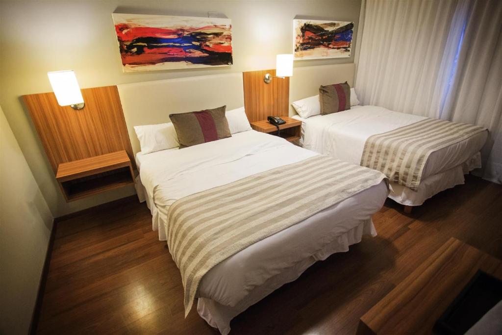 Postel nebo postele na pokoji v ubytování Hotel Bicentenario Suites & Spa
