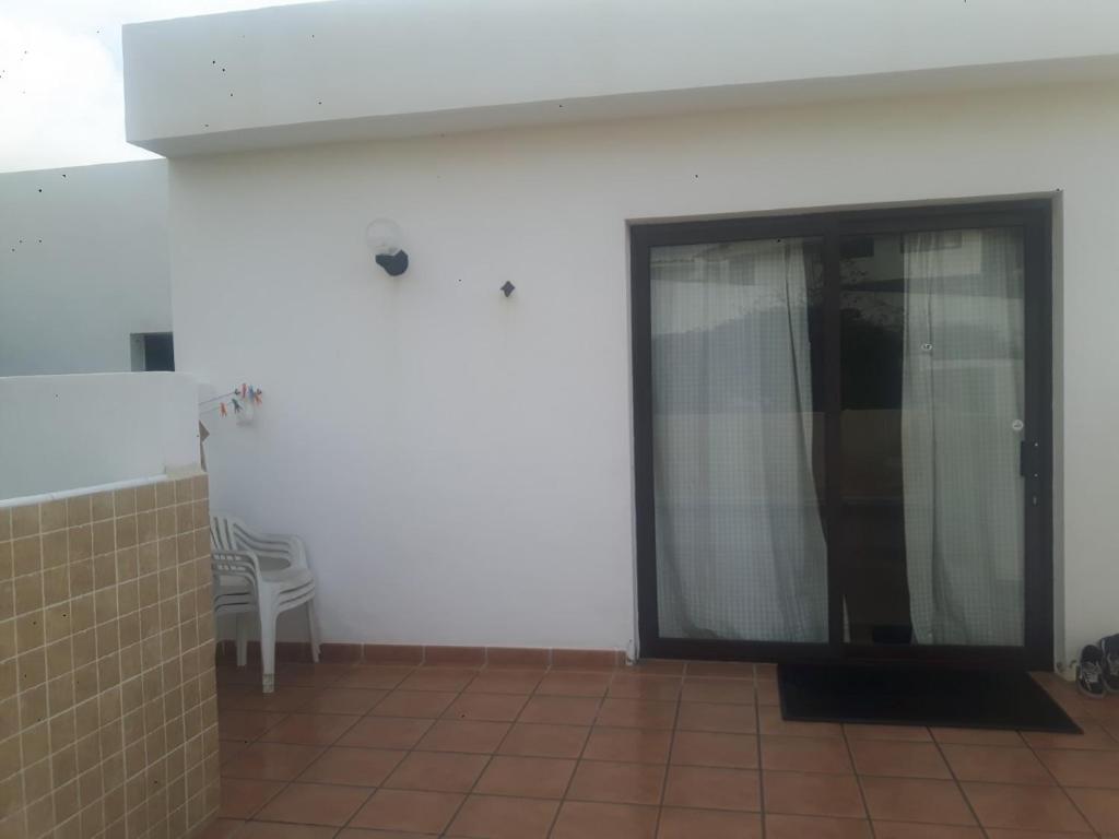 a room with a glass door with a chair in it at Blue Beach in Famara
