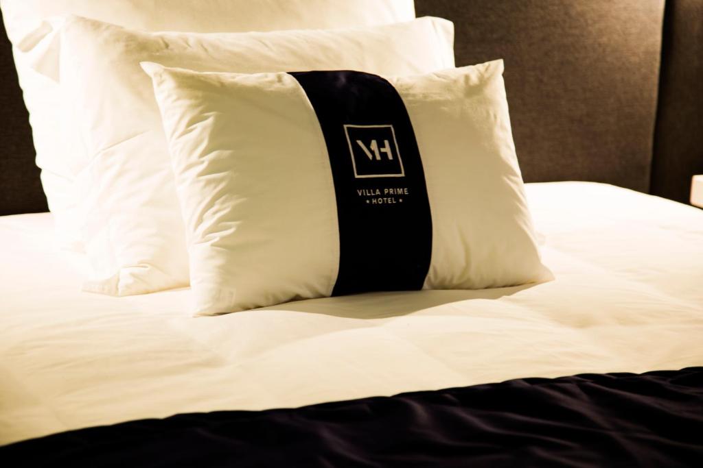 Postel nebo postele na pokoji v ubytování Villa Prime Hotel