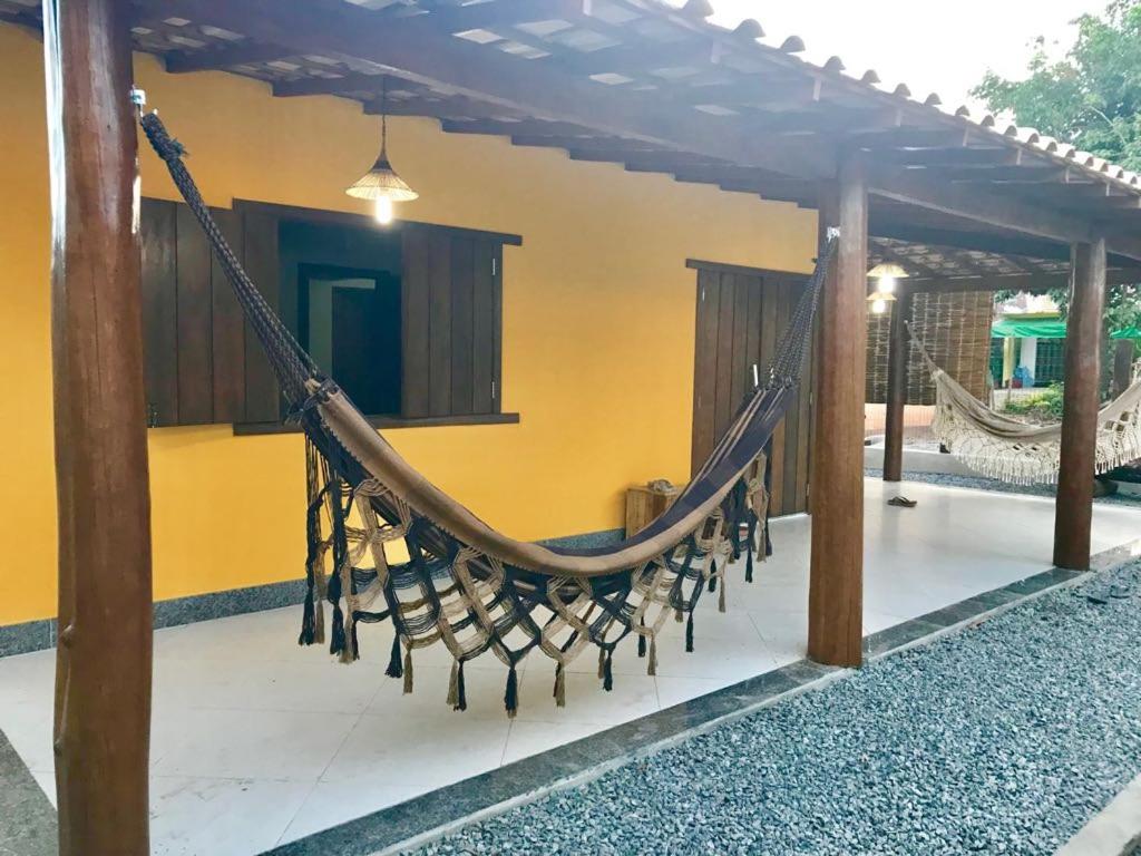 a hammock hanging from a porch of a house at Casa Barra Grande in Barra Grande