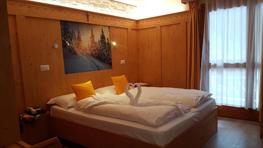 Postel nebo postele na pokoji v ubytování Alps Oriental Wellness HOTEL