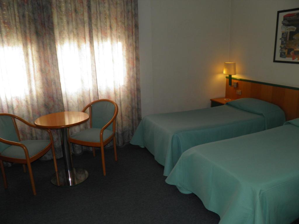 Postel nebo postele na pokoji v ubytování Hotel Ramoverde