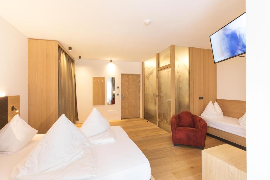 A bed or beds in a room at Belvenu Boutique Hotel