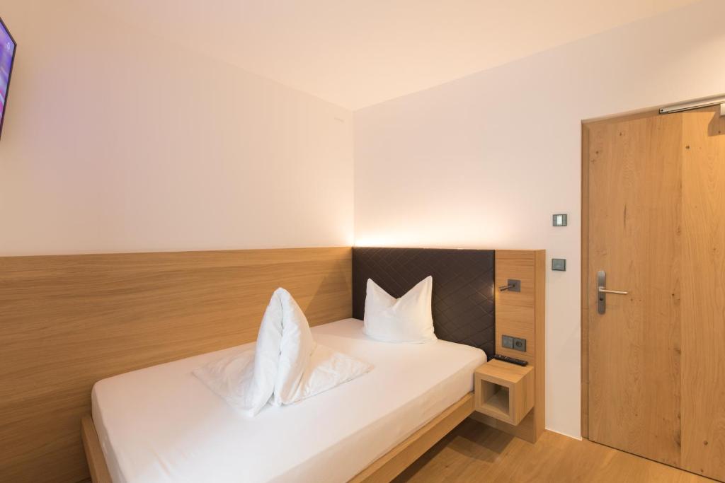 A bed or beds in a room at Belvenu Boutique Hotel