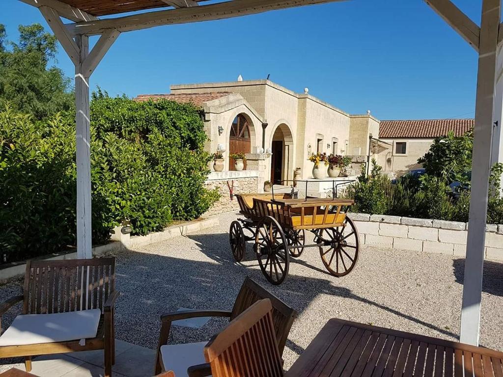 a horse drawn carriage in front of a building at Masseria Sucéa in Martano