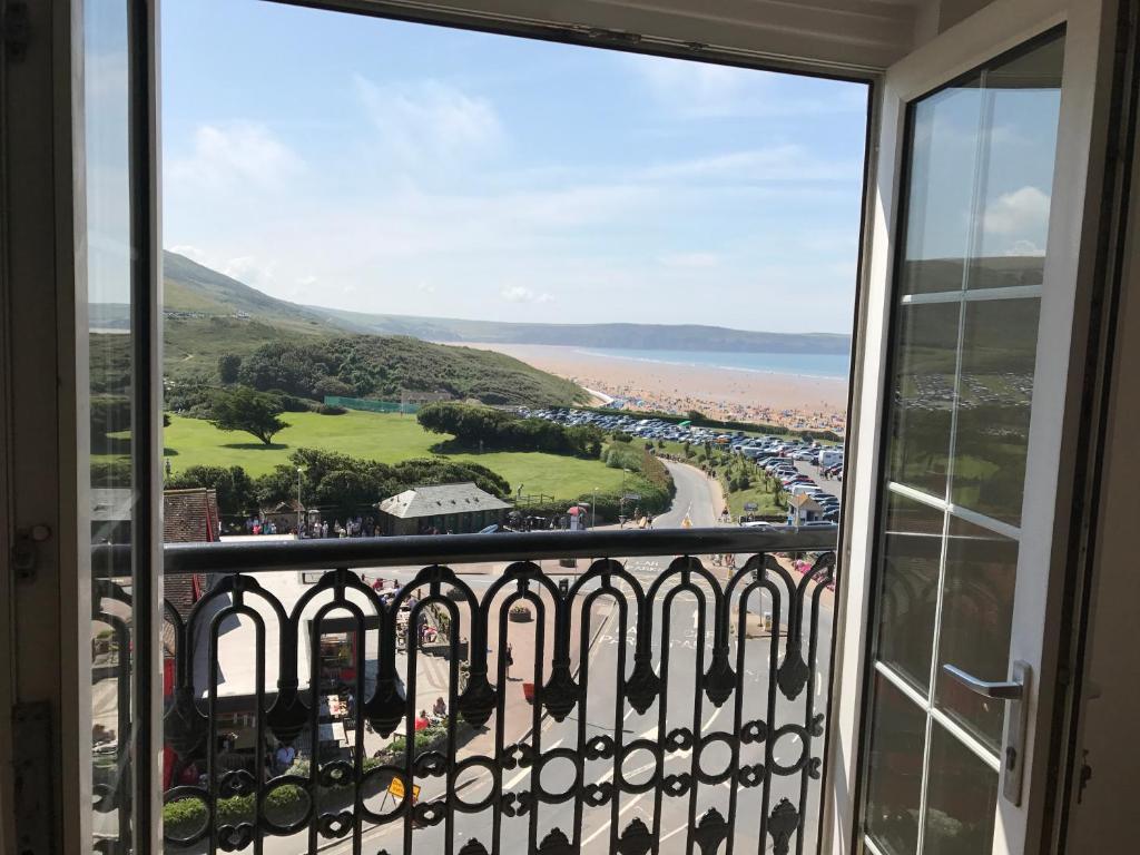 a view of the beach from a balcony at 5, Sandleigh Apartment in Woolacombe