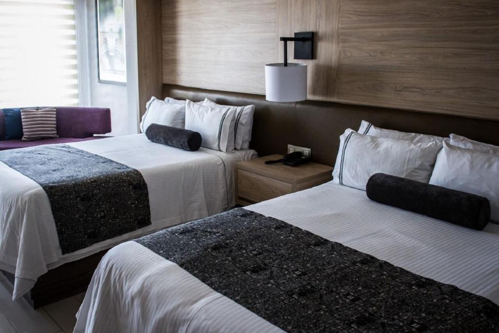 Postel nebo postele na pokoji v ubytování Hotel Real Maestranza