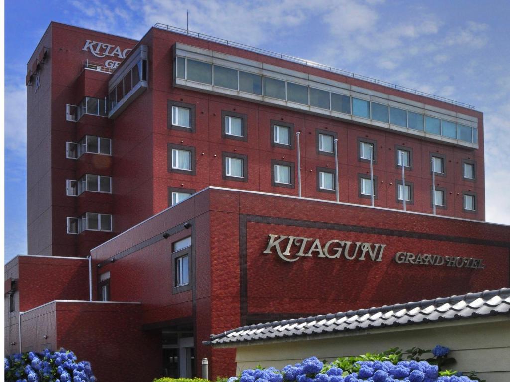 a red building with a kryptonian sign on it at Kitaguni Grand Hotel in Rishirifuji