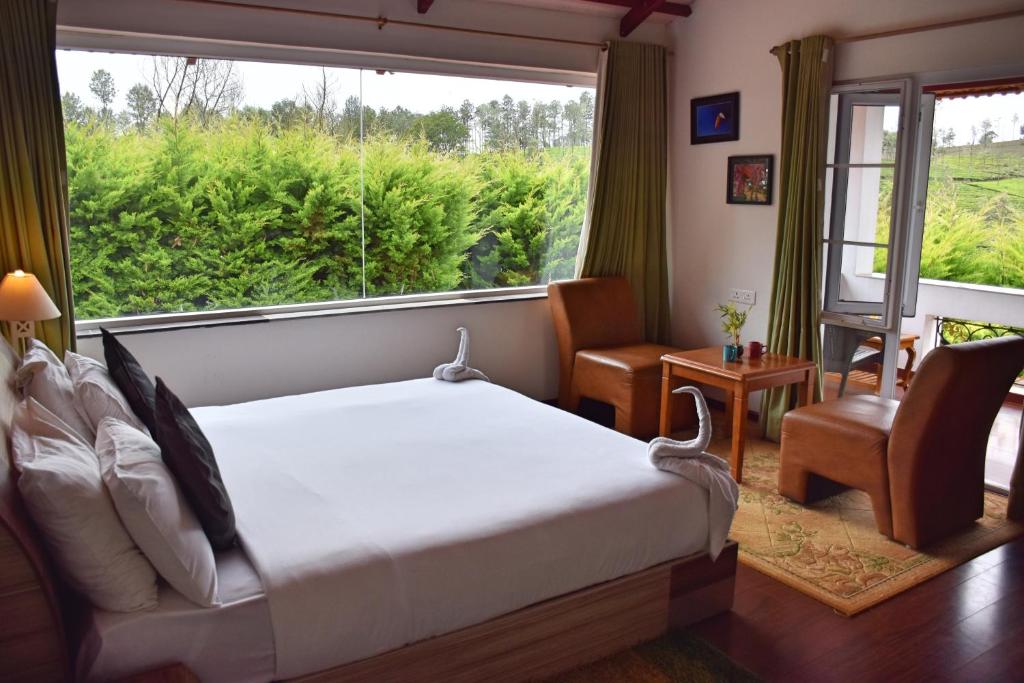 Postel nebo postele na pokoji v ubytování Green Nest Resort Ooty