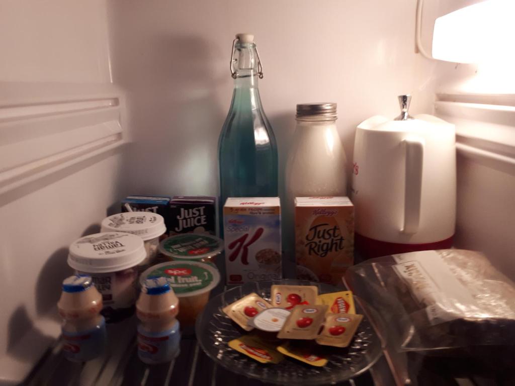 a refrigerator filled with food and a bottle of milk at Gaerwood B&B in Keith