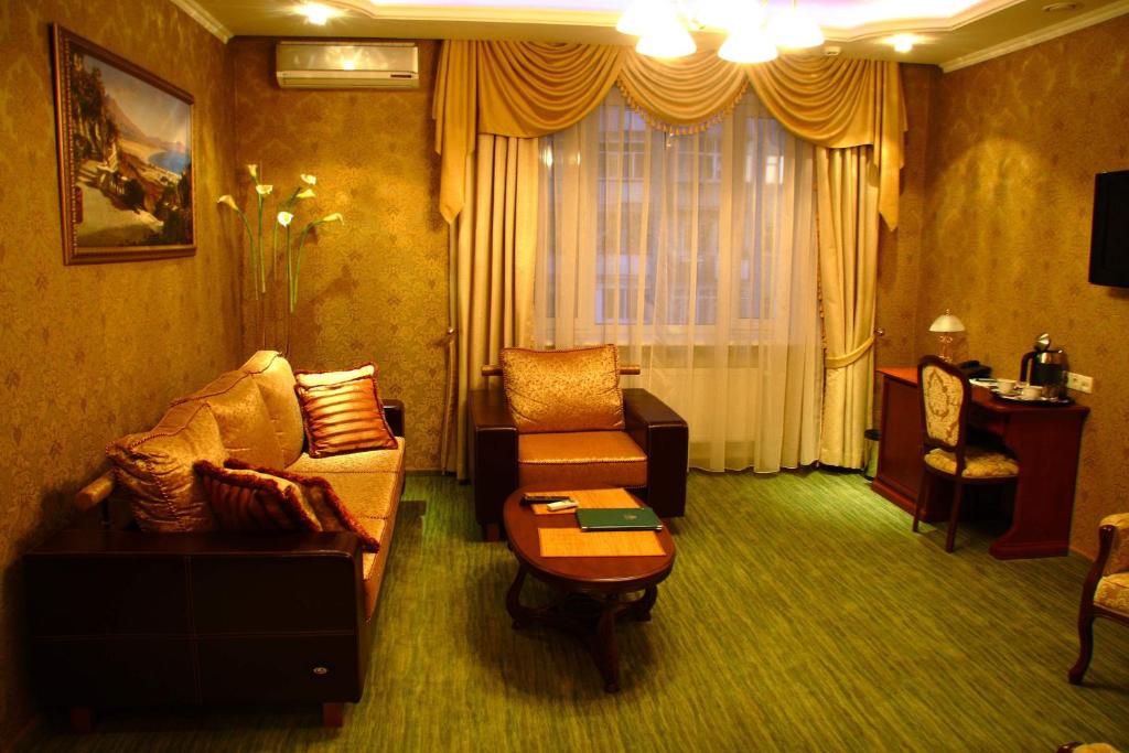 a living room with a couch and a table at Oazis Hotel in Saratov