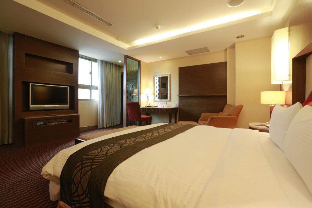 a hotel room with a large bed and a television at Jingan Classic Inn in Zhonghe