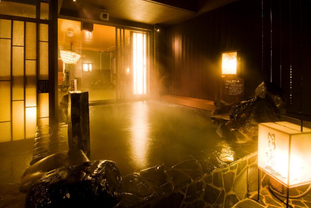 a room with a pool of water in a building at Dormy Inn Premium Shimonoseki in Shimonoseki