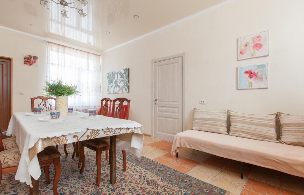 a dining room with a table and two chairs at Guesthouse on Kyzyl-armeyskaya in Kazan