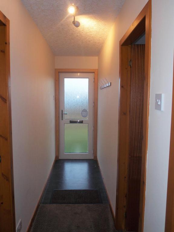 an empty hallway with a door to a room at Riverside in Tarbert